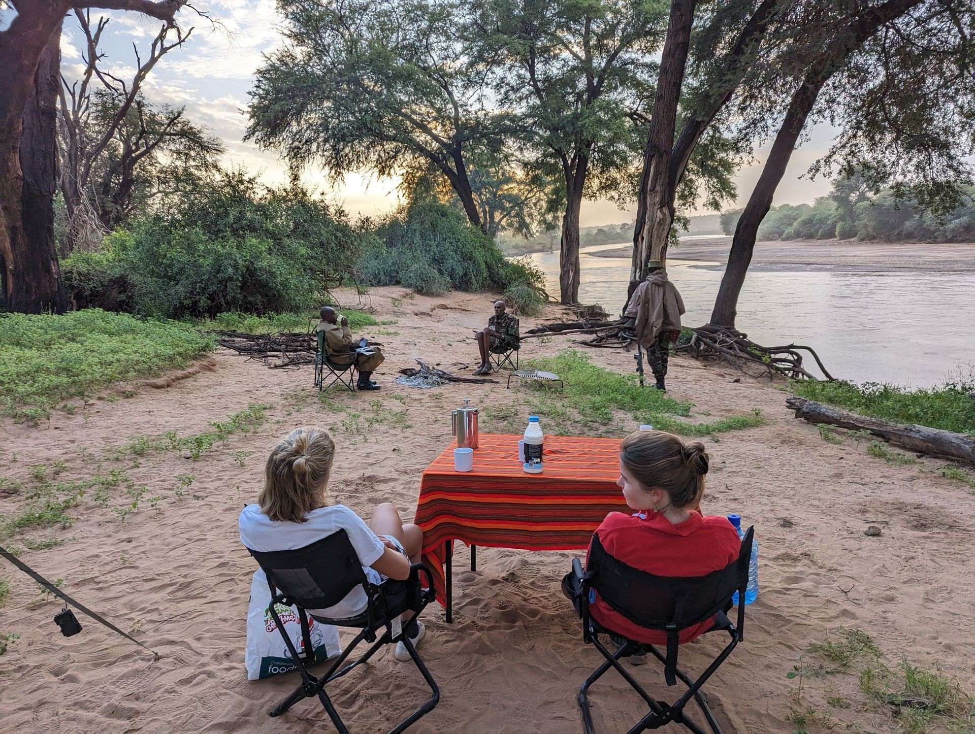 View of Samburu National Park with camping tents set up near riverbed